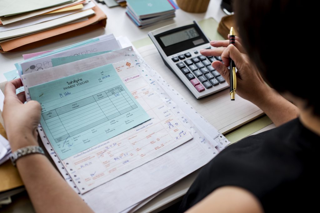 Asian Woman Working Through Paperwork 1 1024x683