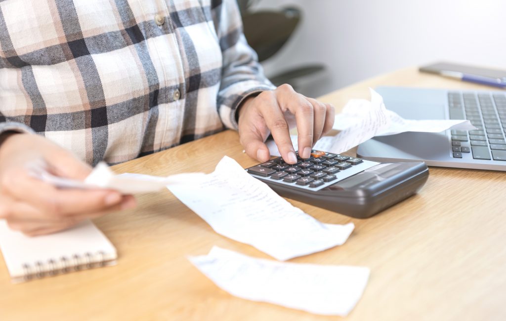 Business Woman Pressing Calculator Calculate Various Costs That Must Be Paid By Bill Invoices Held Placed Table 1024x650