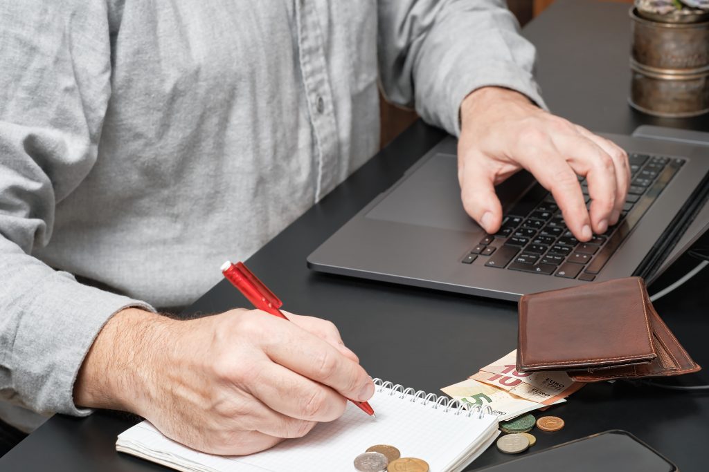 Businessman Accountant Holding Pen Working Desk Using Laptop Calculate Financial Report 1024x683