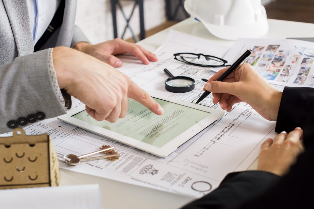 Businessmen Analyzing Business Plan Tablet 1024x683
