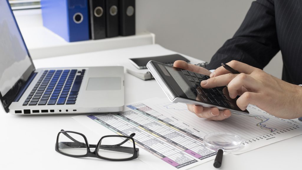 Side View Business Man Calculating Finance Numbers 1024x576