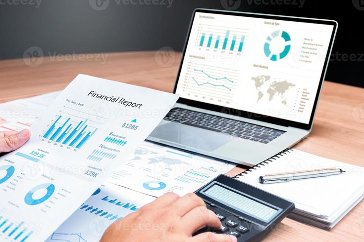 Businessman Hand Holding Financial Report Document With Slide Show Presentation On Display Laptop And Calculator Notebook On Table In Meeting Room